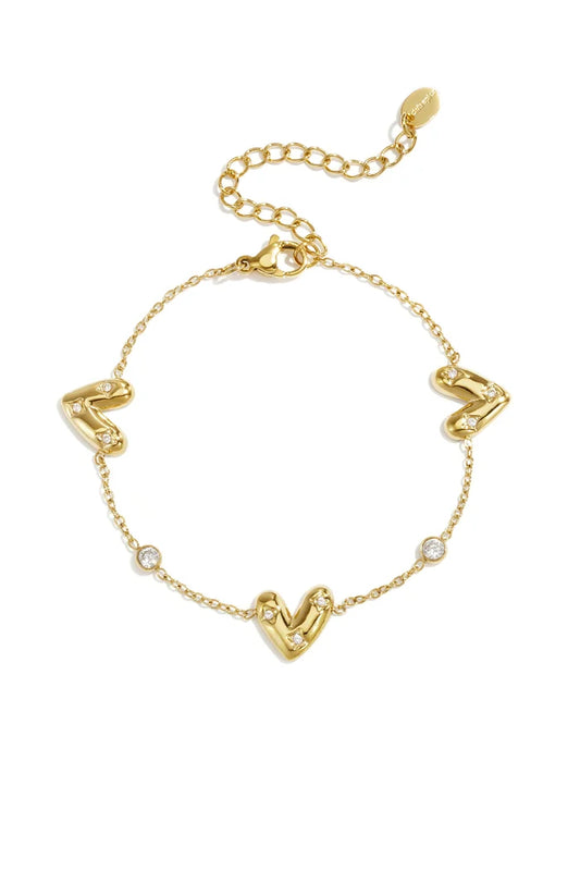 Drie belegde harten en ronde zirkonia steentjes armband goud