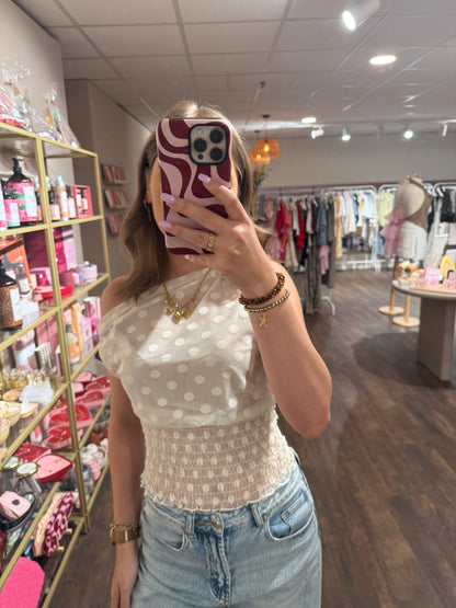 One shoulder top met stippen 