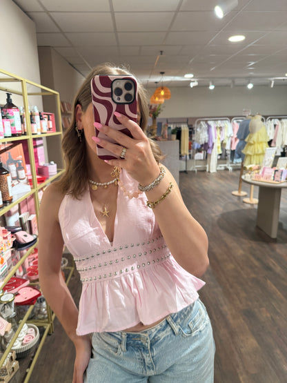 Stoere en vrouwelijke roze top voor de zomer