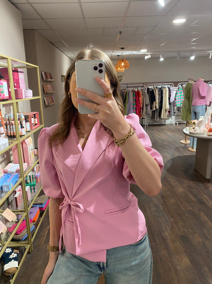 Roze blazer die casual en chic te dragen is.